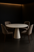 Atlas — Round Corian Dining Table in a dark luxury setting