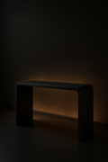 Eclipse — Waterfall Entryway Console in a dark luxury setting