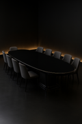 Eclipse — Boat-Shaped Corian Dining Table in a dark luxury setting