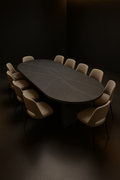 Equinox — Oval Corian Dining Table in a dark luxury setting