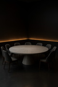 Helios — Round Corian Dining Table in a dark luxury setting