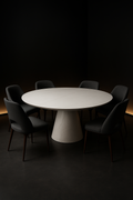 Pearl — Round Corian Dining Table in a dark luxury setting