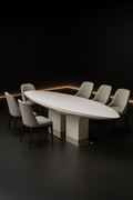 Petal — Boat-Shaped Corian Dining Table in a dark luxury setting