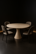 Ridge — Round Corian Dining Table in a dark luxury setting