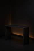 Verve — Waterfall Entryway Console in a dark luxury setting