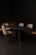 Verve — Boat-Shaped Corian Dining Table in a dark luxury setting