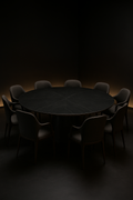 Zephyr — Round Corian Dining Table in a dark luxury setting